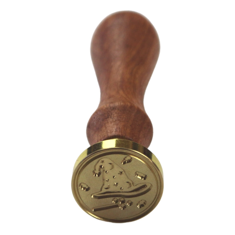 Brass wax seal stamp of a witches hat and wand on a wooden handle