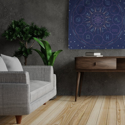 blue astrology tarot cloth/ wall hanging hung on grey tiled wall, above brown side table , next to a grey armchair and  two pot plants with green foliage plants in them