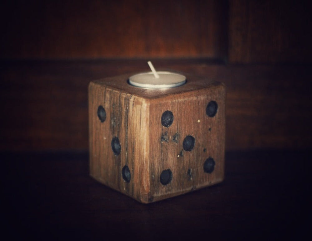 wooden square dice candle with white tea light candle on wooden background