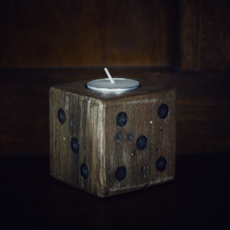 wooden square dice candle with white tea light candle on wooden background