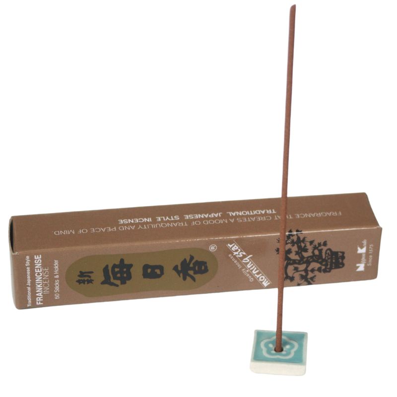 rectangle box of japanese morning star "frankincense" incense sticks next to a tile incense holder