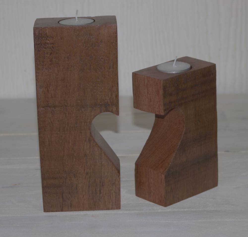 2 wooden candle holders with 1/2 heart cut out of each, paired to make a heart, containing tea light candles, sitting on a white with white background