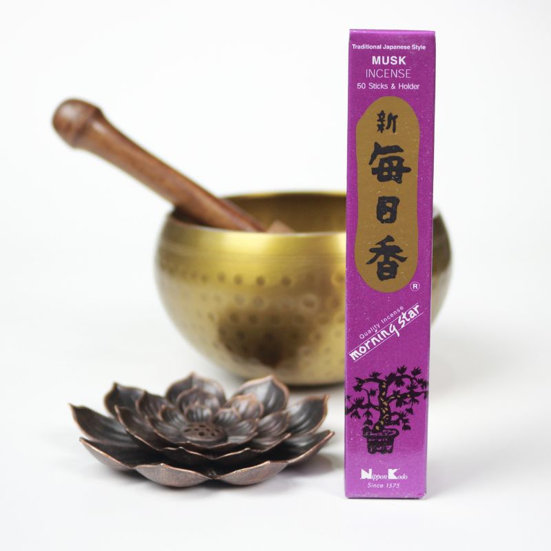 rectangle box of japanese morning star "Musk" incense sticks next to a lotus incense holder and brass singing bowl