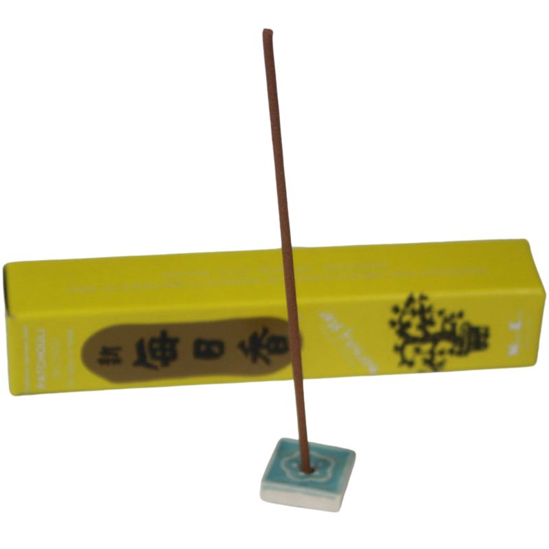 rectangle box of japanese morning star "Patchouli" incense sticks next to a tile incense holder
