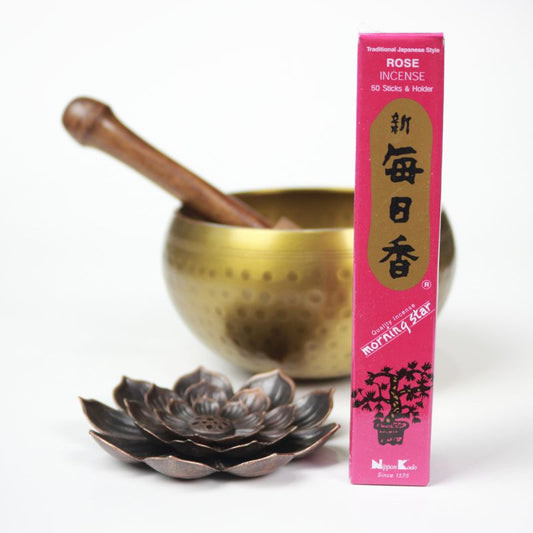 rectangle box of japanese morning star "Rose" incense sticks next to a lotus incense holder and brass singing bowl