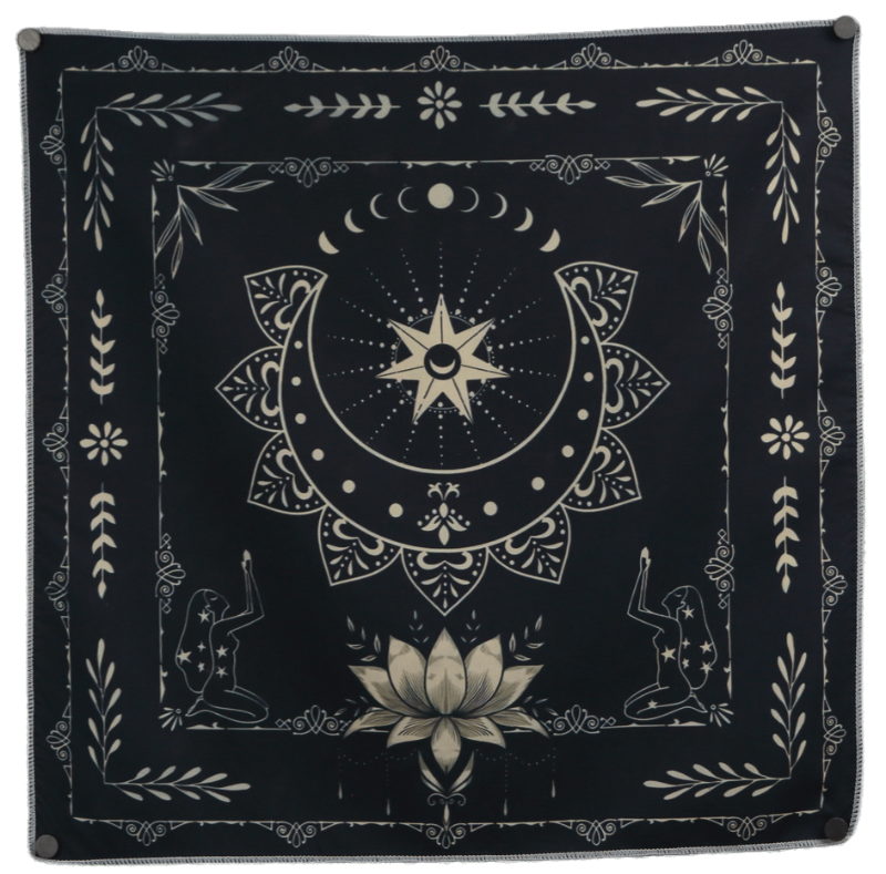 Black and white tarot cloth embellished with a lotus flower and an upturned crescent moon
