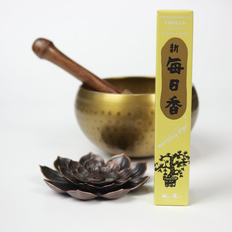 rectangle box of japanese morning star "Vanilla" incense sticks next to a lotus incense holder and brass singing bowl
