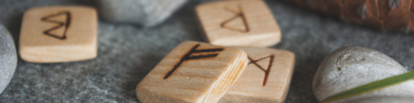 wooden rune tiles next to grey rocks