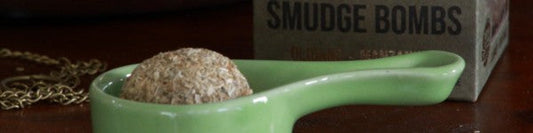 smudge bomb in a green ceramic incense burner