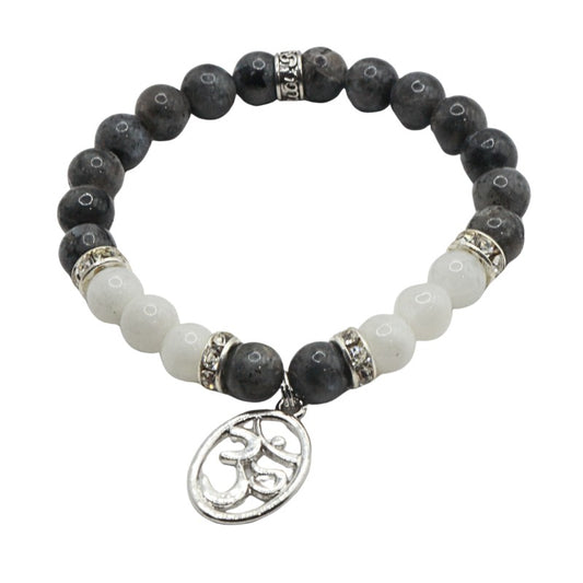 Bracelet with black and white beads and a silver charm on a white background