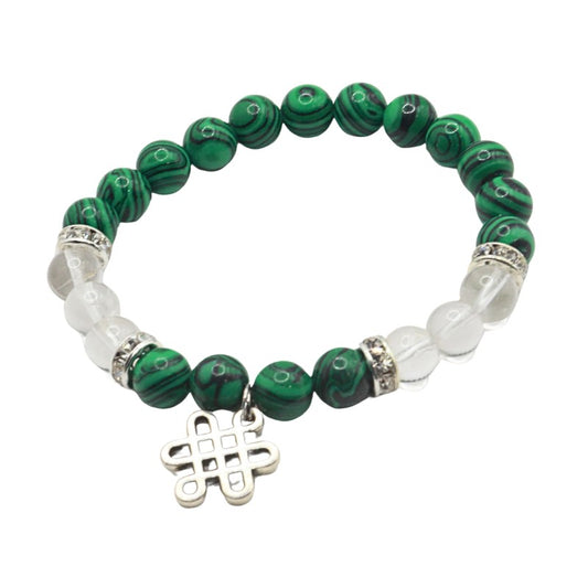 Green beaded bracelet with silver charm on a white background