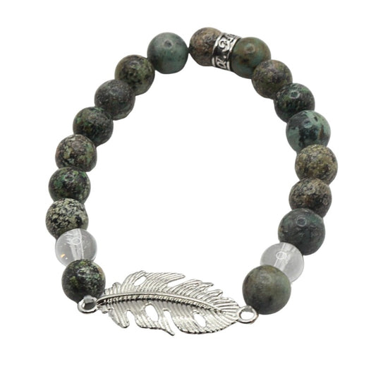 Bracelet with green beads and a silver feather charm on a white background