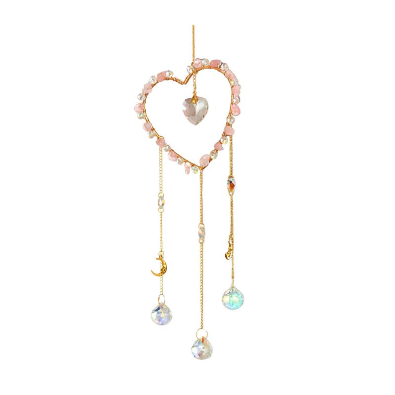 Heart-shaped suncatcher with beads and crystals on a white background