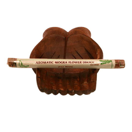 pk of natural tibetan dhoop incense on a pair of open wooden carved hands