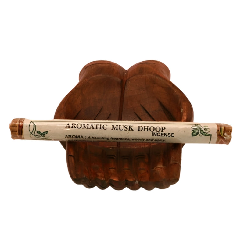 pk of natural tibetan dhoop incense on a pair of open wooden carved hands