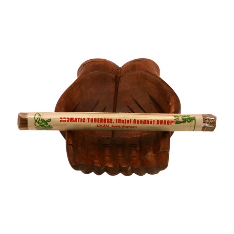 pk of natural tibetan dhoop incense on a pair of open wooden carved hands