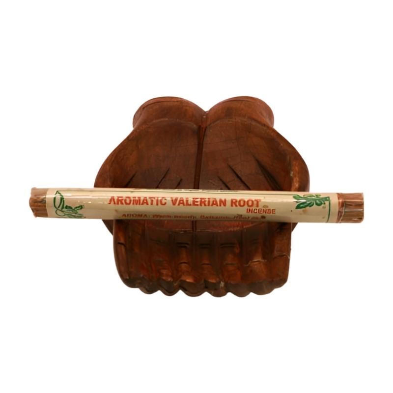 pk of natural tibetan dhoop incense on a pair of open wooden carved hands