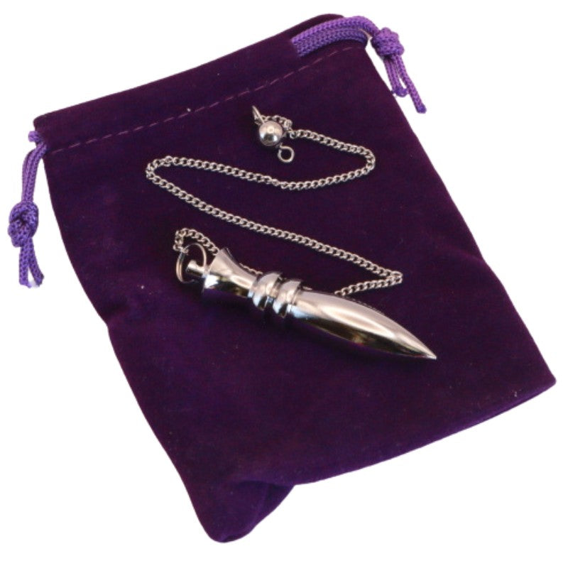 Brass pendulum on purple velvet pouch
