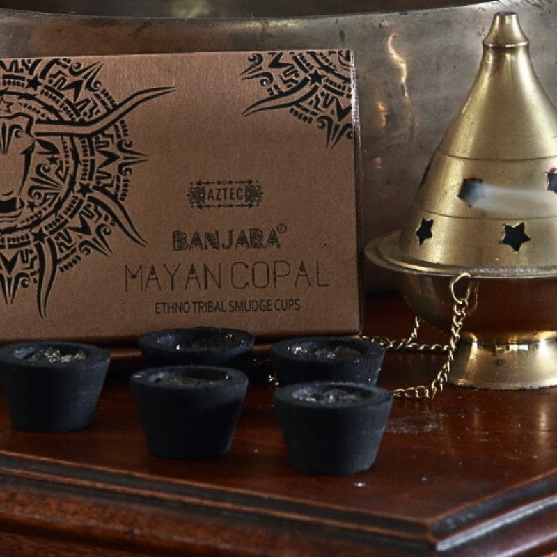 Banjara Smudge cups next to a brass thurible on a wooden table