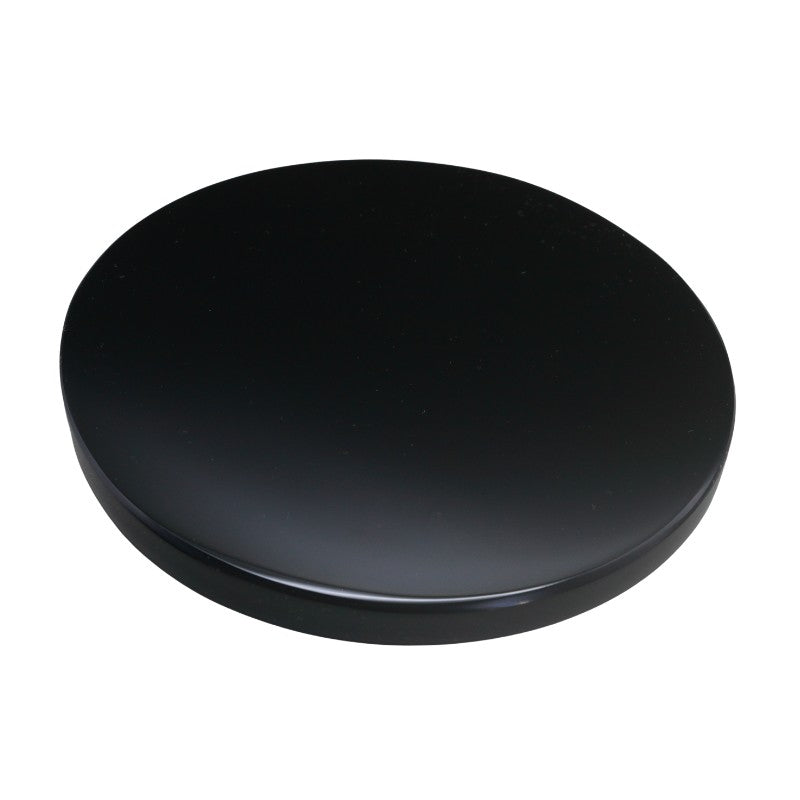 smooth, circular flat piece of black obsidian on a white background 