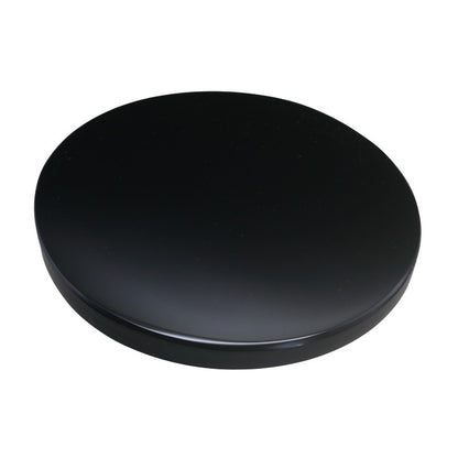 smooth, circular flat piece of black obsidian on a white background 