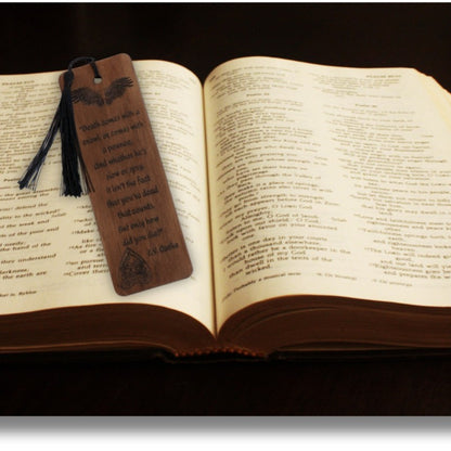 handmade wooden bookmark with black tassel in an open book