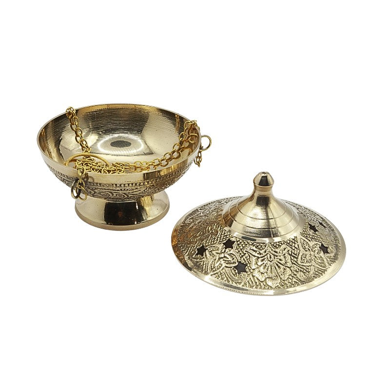Decorative brass incense holder with intricate designs on a white background
