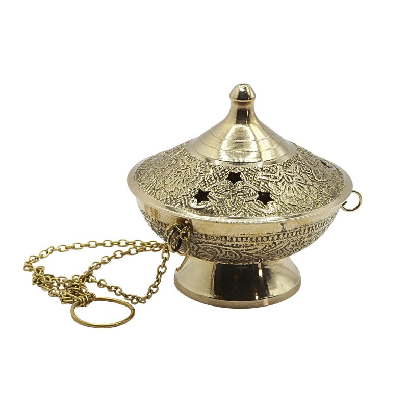 Decorative brass incense burner with intricate designs on a white background