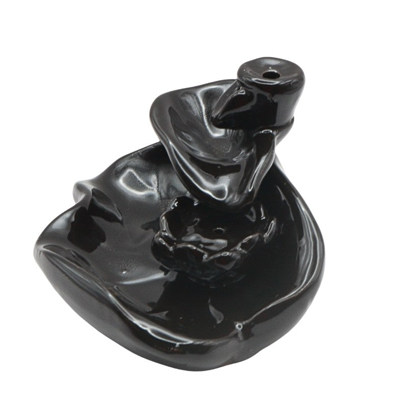 Black ceramic incense burner on a white background