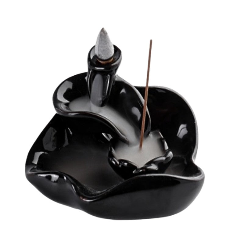 Black ceramic incense burner with a single incense stick on a white background