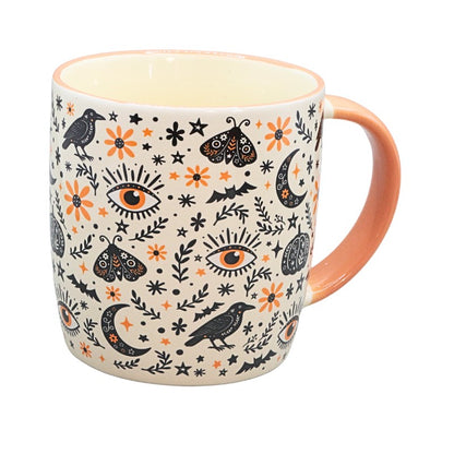 ceramic mug with black and orange spooky designs on a white background