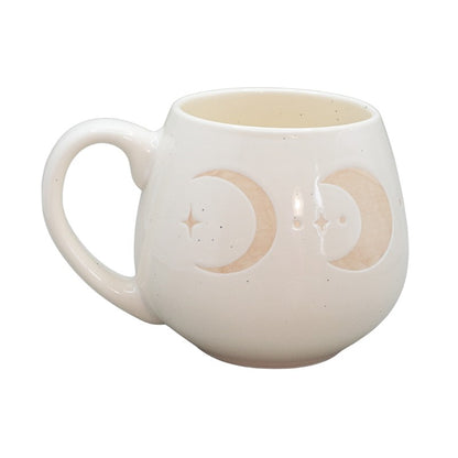 cream mug with crescent moon images on a white background

