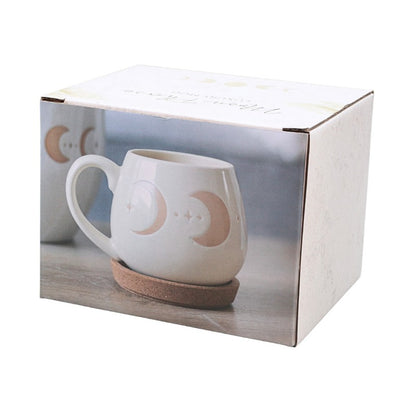 packaging featuring cream mug with crescent moon images on a white background