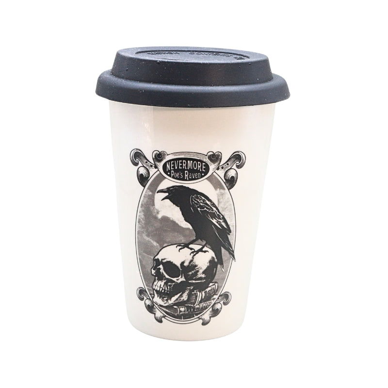 A white reusable coffee mug with a black lid, featuring a gothic-style graphic of a raven perched on a skull inside an oval frame with the text 'NEVERMORE Poe's Raven '.