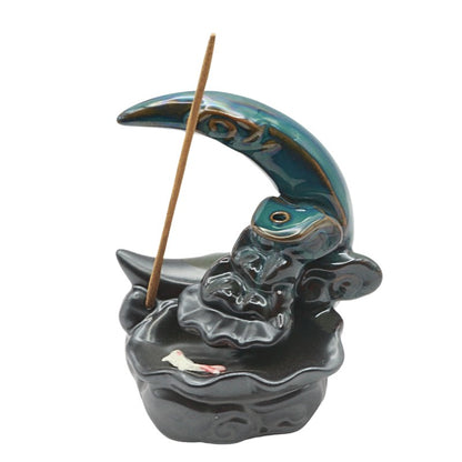 Ceramic incense burner shaped like a crescent moon on a white background.