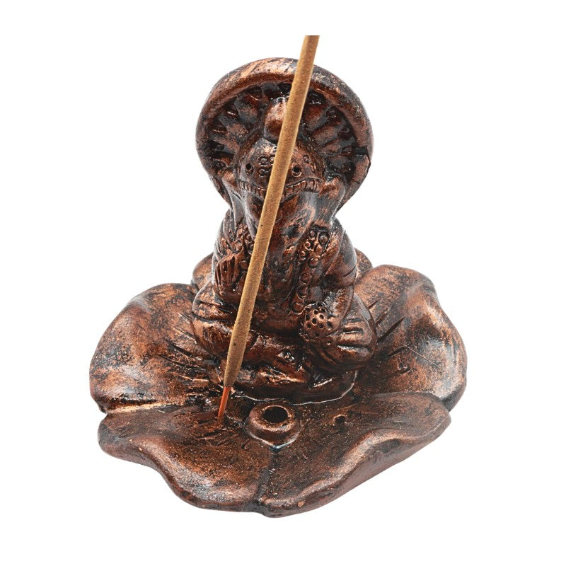 Copper-coloured clay  incense holder with a stick on a white background