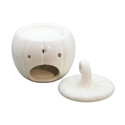 A white ceramic pumpkin-shaped oil burner with a matching lid, shown on a plain white background. The body has star-shaped cutouts on the side and a circular opening at the bottom.
