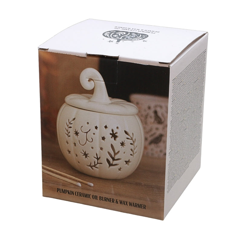 A boxed ceramic oil burner and wax warmer shaped like a small pumpkin, shown in its retail packaging on a white background.