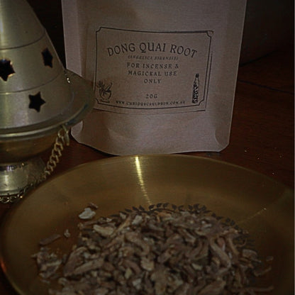 Dong Quai Root packaging with a metal cone and bowl on a wooden surface