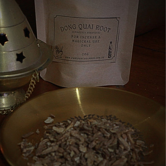 Dong Quai Root packaging with a metal cone and bowl on a wooden surface