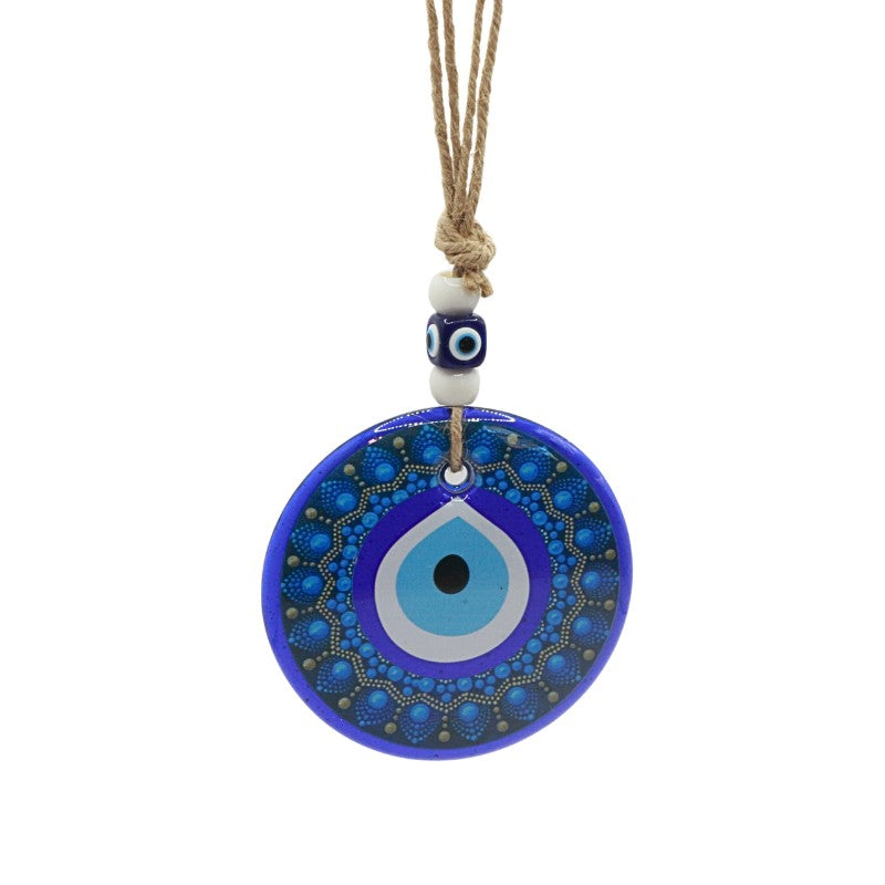 Blue evil eye pendant on a white background
