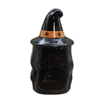 A glossy black witch hat cookie jar with a pointed hat, an orange band decorated with black stars, and a small coin slot on top, shown on a plain white background.