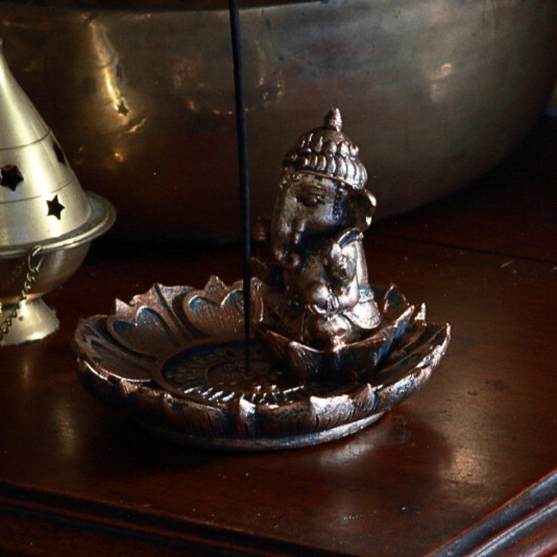 Ganesh incense holder and incense stick on wooden table