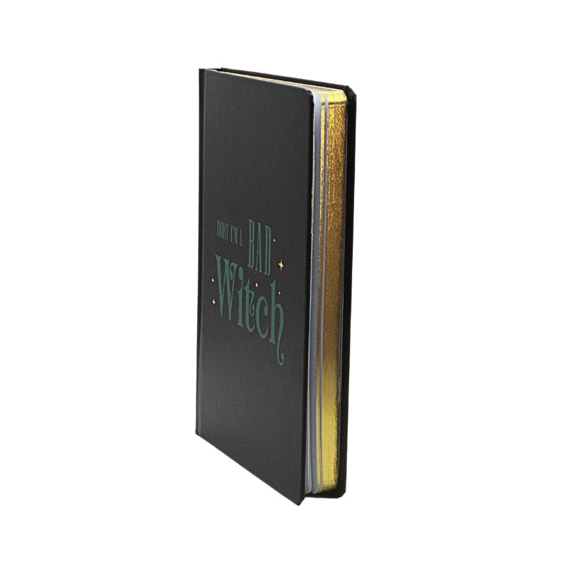 Black notebook with 'I'm a bad witch' text on a white background