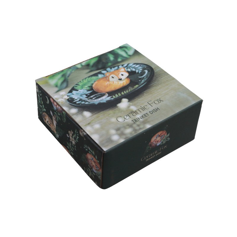 Box packaging for a ceramic fox trinket dish with decorative design.
