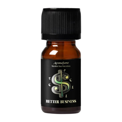 A small amber glass bottle with a black ribbed cap and a black label reading 'Aromafume' and 'Better Business' with a stylized green and silver dollar sign, on a plain white background.