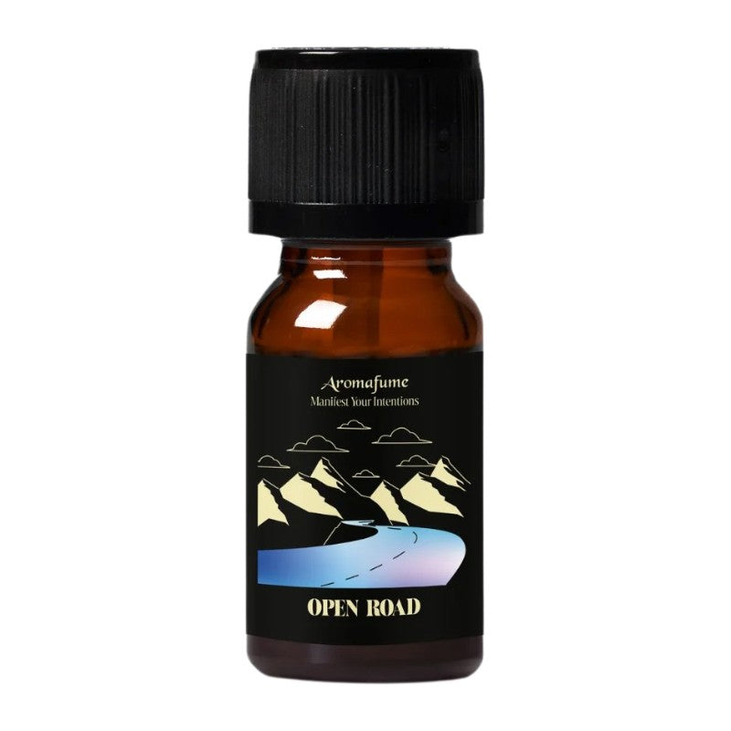 A small amber glass bottle with a black ribbed cap and a black label. The label features a graphic of mountains and a winding road, with the brand name 'Aromafume' and the scent name 'OPEN ROAD' visible.