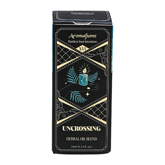 A rectangular black box for Aromafume 'Uncrossing' Herbal Oil Blend, featuring gold geometric borders and teal illustrations of a candle and leaves on a white background.