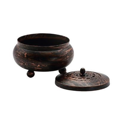 black and bronze coloured, round metal charcoal burner and lid