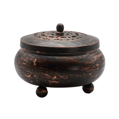 black and bronze coloured, round metal charcoal burner 